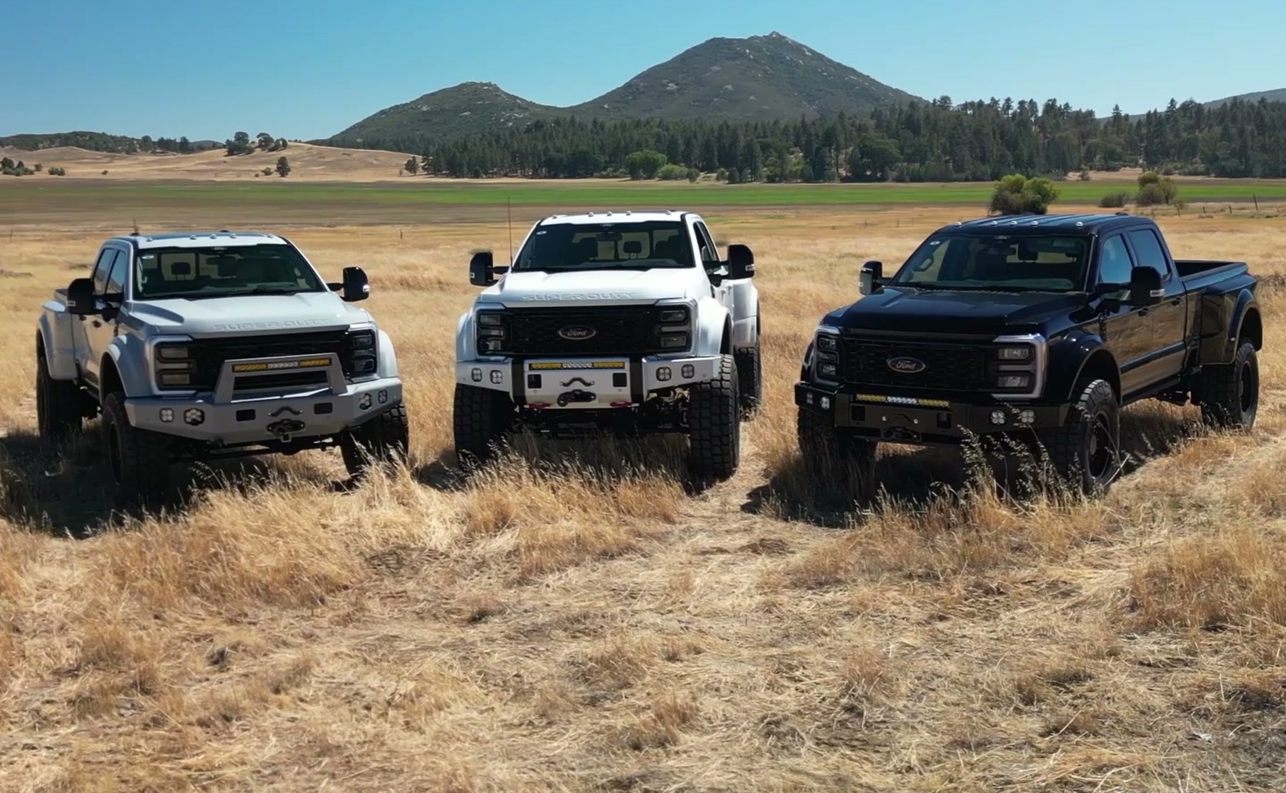 Three finished MAV F-450 builds parked in a field