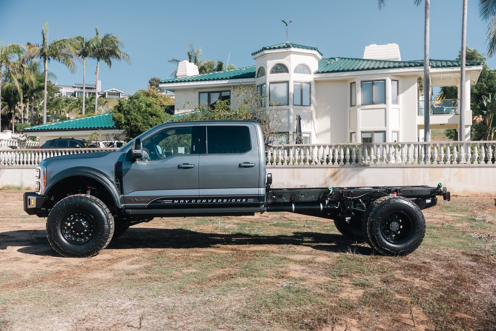 Ford F-550 cab chassis in full profile, bare frame rails behind the crew cab